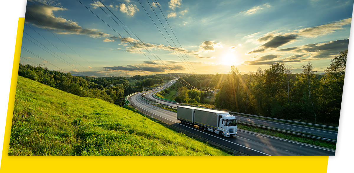 Goodyear truck driving through a green landscape